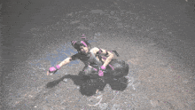 a woman in a purple and black outfit is kneeling down on the ground