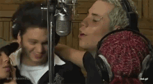 a group of people are in front of a microphone and the words wm channel are on the bottom right