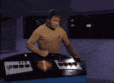 a man is dancing in a room with a purple wall and a machine in the background .