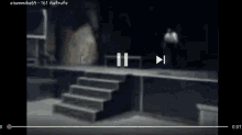a blurry picture of a person walking down stairs at night .