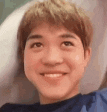 a close up of a person 's face with a smile on their face .