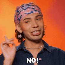 a man wearing a bandana and a denim shirt is saying no