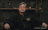 a man in a black shirt with the word evil on it screams