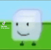 a white cube with a smiling face is standing in a field .