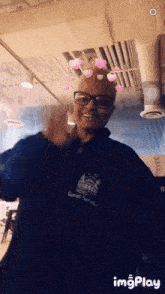 a man wearing glasses and a guest service shirt
