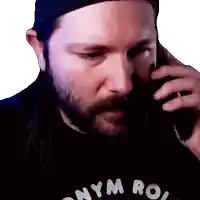 a man with a beard is talking on a cell phone and his shirt says nym ro