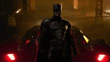 a man in a batman costume stands in front of a car