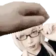 a woman wearing glasses and a hat with a hand covering her face .