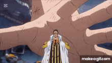 a man in a white coat is standing in front of a giant hand .