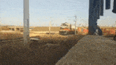 a sign on a pole that says eo is next to a train track