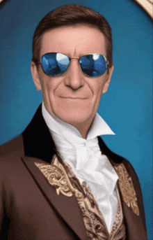 a man wearing a suit and sunglasses is smiling