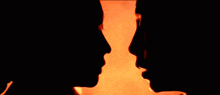 a couple kissing in front of a fire with angrytoon written on the bottom right