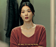 a woman in a red sweater is saying no way it 's not my thing