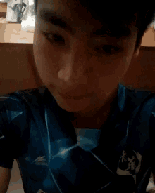 a close up of a person wearing a blue shirt