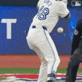 a baseball player with the number 18 on his jersey swings at the ball