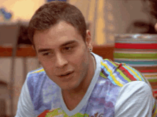 a man wearing a colorful shirt that says ' nyc ' on the front