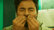 a man with his eyes closed is eating something