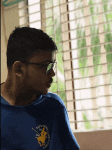 a man wearing glasses and a santa monica polo club shirt