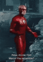 a man in a red superhero suit is talking to another man in a red superhero suit
