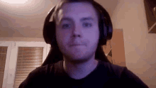 a man wearing headphones and a black shirt
