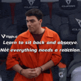 a man in an orange jumpsuit is sitting in a seat with a cupra logo on it