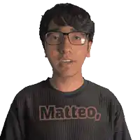 a young man wearing glasses and a black shirt that says matteo