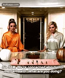 two women are standing next to each other on a kitchen counter talking about mental health .