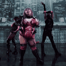 a woman in a red bodysuit is dancing in front of a city skyline