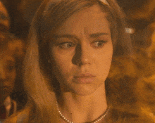a woman in a pearl necklace is asking is that a good thing