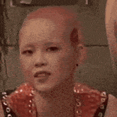 a close up of a woman 's face with a shaved head