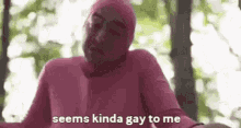 a man in a pink suit is talking about being gay .