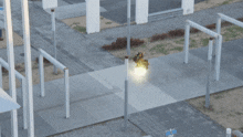 an aerial view of a street with a light coming out of a pole