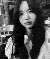 a black and white photo of a girl with long hair .