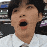 a man in a white shirt and tie is making a funny face .