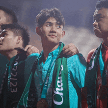 a man wears a medal around his neck that says chang