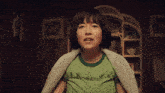 a woman in a green t-shirt with stars on it