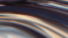 a blurred image of a rainbow colored swirl