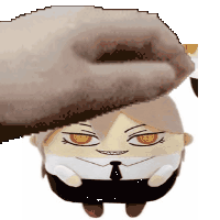 a hand is putting a stuffed animal on top of a stuffed animal .