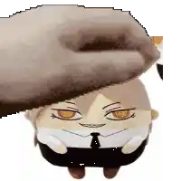 a hand is putting a stuffed animal on top of a stuffed animal .
