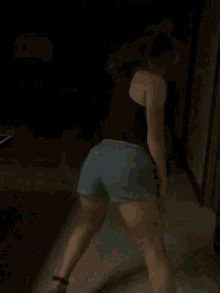 a woman in shorts and a tank top is dancing