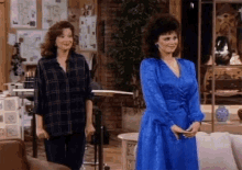two women standing next to each other in a living room