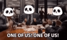 a group of people are sitting at a table with pandas on their faces .