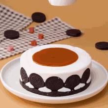 a cake with oreos on it and a caramel sauce on top