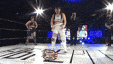 a woman stands in a wrestling ring holding a trophy that says eol-e300