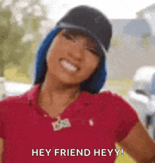 a woman wearing a hat and a red shirt is smiling and says hey friend heyy !