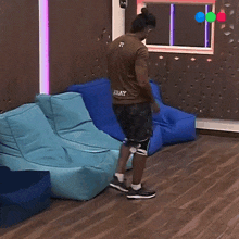 a man is sitting on a blue bean bag chair