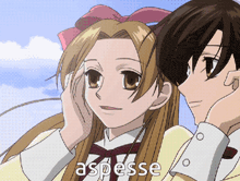 a boy and a girl are standing next to each other and the girl 's hand is on the boy 's ear