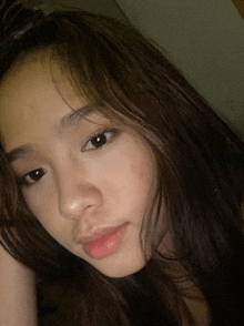 a close up of a girl 's face with a red spot on her face