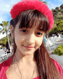 a young girl wearing a red headband and a red dress