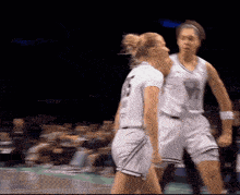 two female basketball players one of whom is wearing number 23